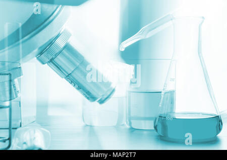 three erlenmeyer flask and microscope , Glassware on  science laboratory research and development Stock Photo