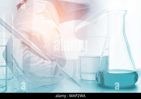 three erlenmeyer flask and microscope , Glassware on  science laboratory research and development Stock Photo