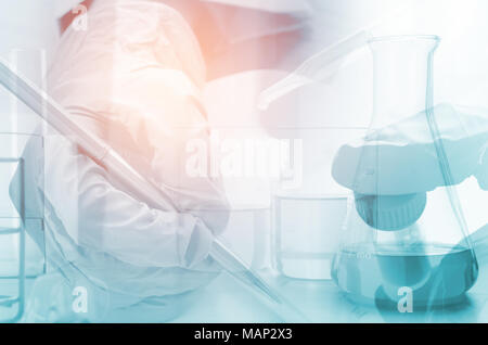 three erlenmeyer flask and microscope , Glassware on  science laboratory research and development Stock Photo