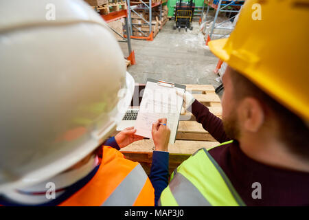 Workers Looking at Plans Stock Photo
