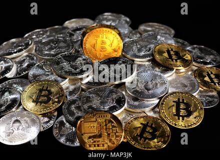 Bit coins with silver dollars and diamonds. Stock Photo