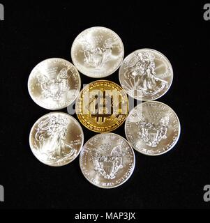 Bit coins with silver dollars and diamonds. Stock Photo
