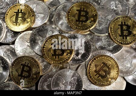 Bit coins with silver dollars and diamonds. Stock Photo