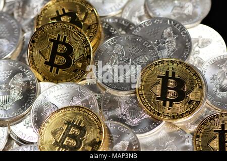 Bit coins with silver dollars and diamonds. Stock Photo