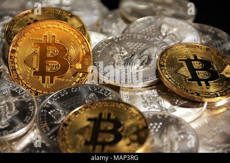 Bit coins with silver dollars and diamonds. Stock Photo
