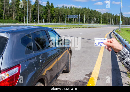 Moscow, Russia - August 31, 2017: Road ticket for toll road Russian highway number M11 in summer day. Text in Russian: Road ticket Stock Photo