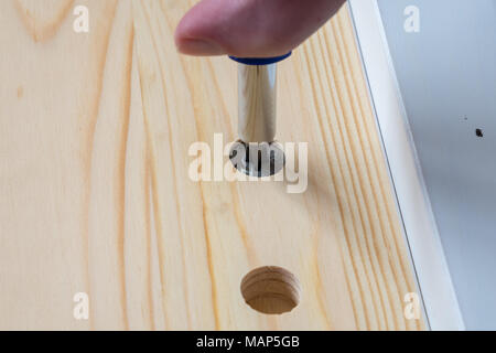 Screwing together flat pack furniture fixings Stock Photo