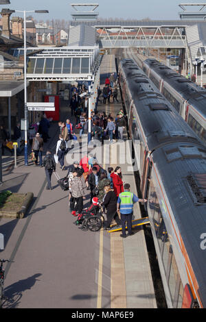 Passengers, including one in disabled in a  wheelchair boarding a East MIdlands trains meridian express train at  Loughborough railway station Stock Photo