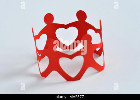 Paper people in a circle holding hands on white background - Teamwork and love concept Stock Photo