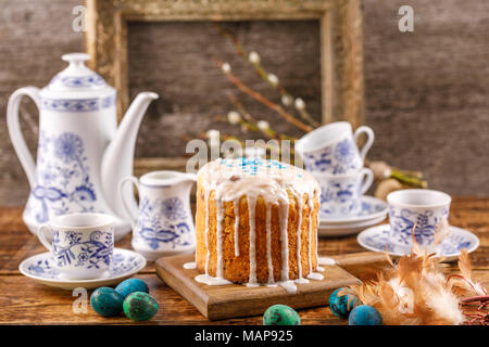 Easter in a rustic style. Easter table with Easter cakes and Easter eggs with willow branches. Still life with an ancient frame for a picture in the b Stock Photo