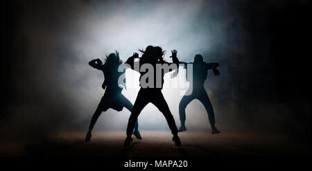 Group of young dancers performing modern dance isolated on white ...