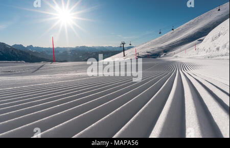 panorama view of a ski resort with freshly groomed ski slopes and ski lifts on a gorgeous winter day with a fantastic view of the surroundings Stock Photo