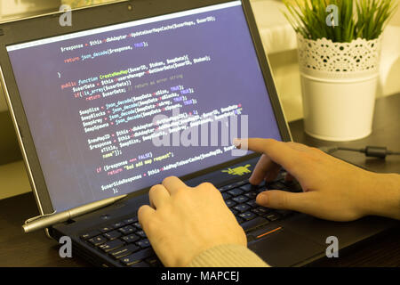 Web developer typing a PHP program on keyboard. Digital technology modern background. Stock Photo