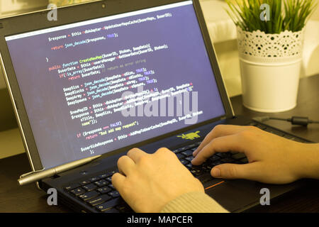 Web developer typing a PHP program on keyboard. Digital technology modern background.