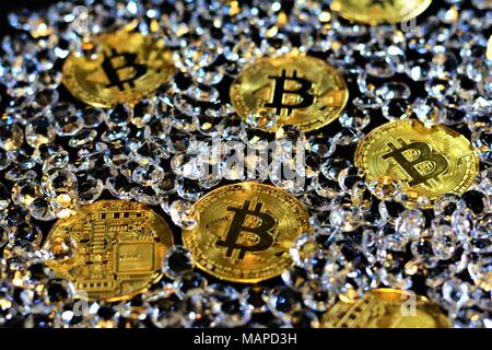 Bit coins with silver dollars and diamonds. Stock Photo