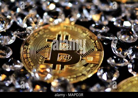 Bit coins with silver dollars and diamonds. Stock Photo