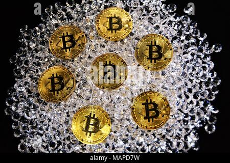 Bit coins with silver dollars and diamonds. Stock Photo
