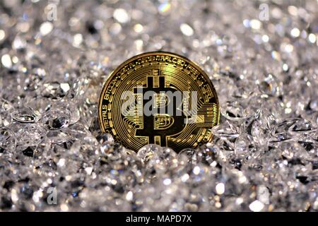 Bit coins with silver dollars and diamonds. Stock Photo