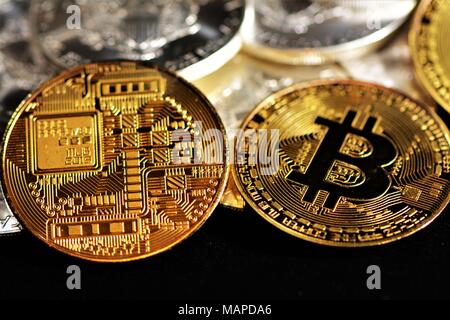 Bit coins with silver dollars and diamonds. Stock Photo