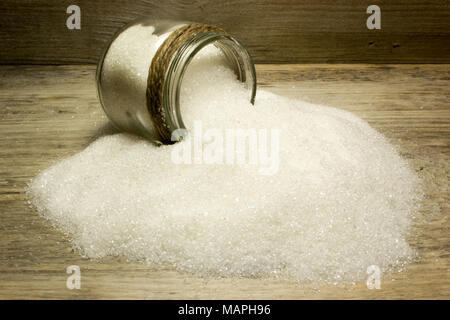 Sugar in glass jar on wooden background Stock Photo