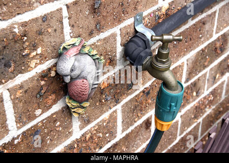 Garden water tap on a brickwall Stock Photo