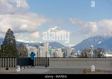 Man photographing the Vancouver city skyline and North Shore Mountains from a lookout, Vancouver, BC, Canada Stock Photo