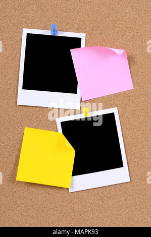 Blank photo prints with sticky notes pinned to a cork bulletin board. Stock Photo