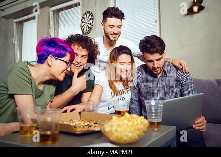 A group of friends of students in leisure with a laptop together Stock Photo