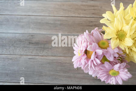 Retro image, pink and yellow flower in bamboo vase on table, vintage background, Stock Photo