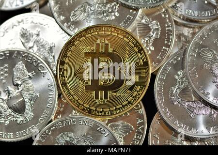 Bit coins with silver dollars and diamonds. Stock Photo