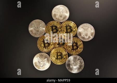 Bit coins with silver dollars and diamonds. Stock Photo