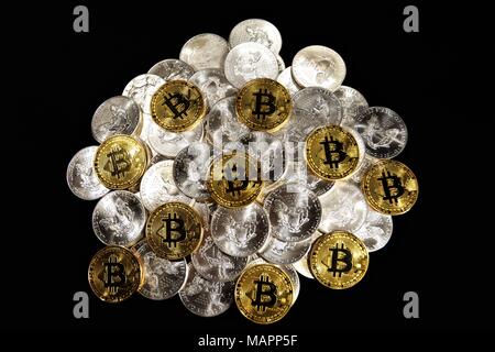 Bit coins with silver dollars and diamonds. Stock Photo
