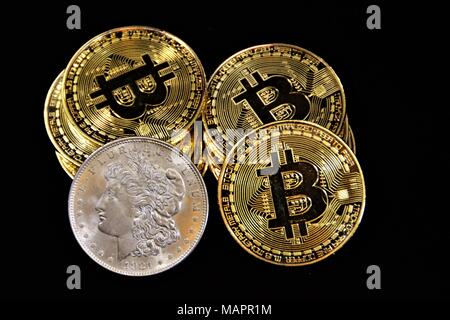Bit coins with silver dollars and diamonds. Stock Photo