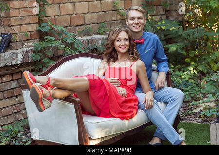 Happiness couple embrace, relaxing in park and looking at camera. Outdoor shot Stock Photo