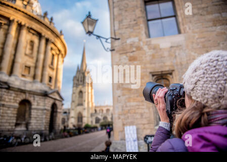 Photographer photographing St. Mary's Church and The Radcliffe Camera in Radcliffe Square, Oxford, Oxfordshire, England, United Kingdom, Europe Stock Photo