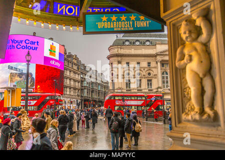 Red buses travelling through Piccadilly Circus from the Criterion Theatre, London, England, United Kingdom, Europe Stock Photo