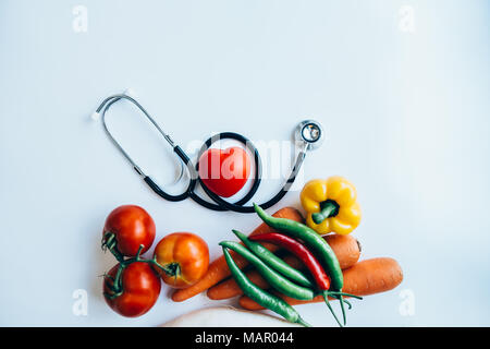 close up red heart and stethoscope on white background, world health day concept, process vintage tone Stock Photo