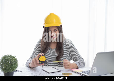 Architect or planner working on drawings for construction plans at a table Stock Photo