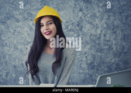 Architect or planner working on drawings for construction plans at a table Stock Photo