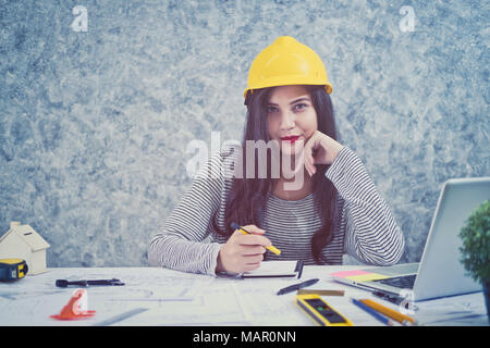 Architect or planner working on drawings for construction plans at a table Stock Photo