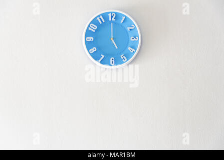 Good afternoon or after midnight with 5:00 clock on white concrete wall interior background with copy space, message board concept. 5 pm is a coffee b Stock Photo