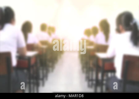 Students studying or taking examination in Classroom, university education concept background, defocus blur effect Stock Photo