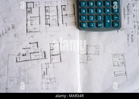 Architect sketches on paper and calculator on office desk Stock Photo