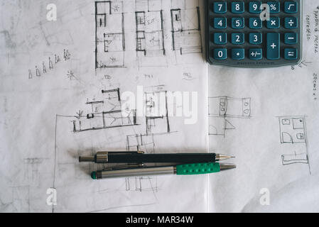 Architect sketches on paper and calculator on office desk Stock Photo