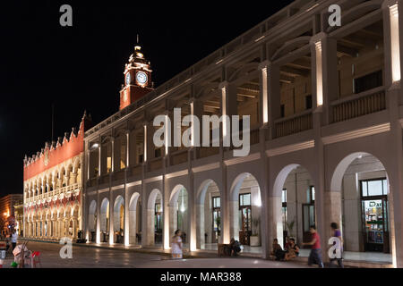 MERIDA, MEXICO - march 11, 2012: Night view of Municipal Palace (Palacio Municipal) with clock tower and street with people in Merida, Yucatan, Mexico Stock Photo