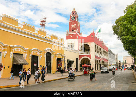 MERIDA, MEXICO - march 11, 2012: Day view of Municipal Palace (Palacio Municipal) with clock tower and street with people in Merida, Yucatan, Mexico Stock Photo