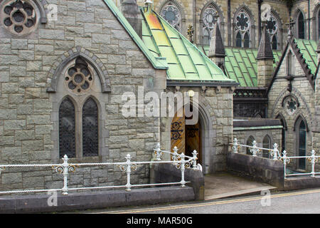 The rooftop, colums and towers of the gothic style St Colmans Roman Catholic Cathedral in the town of Cobh in County Cork ireland Stock Photo