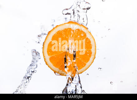 Free floating/suspended Orange with water stream or fountain Stock Photo