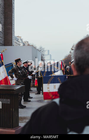 PARIS, FRANCE - MAR 24,2018: soldiers raise French flags under the Triumphal Arch, pay tribute, the military. Stock Photo