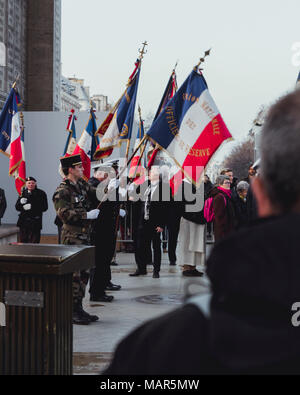 PARIS, FRANCE - MAR 24,2018: soldiers raise French flags under the Triumphal Arch, pay tribute, the military. Stock Photo